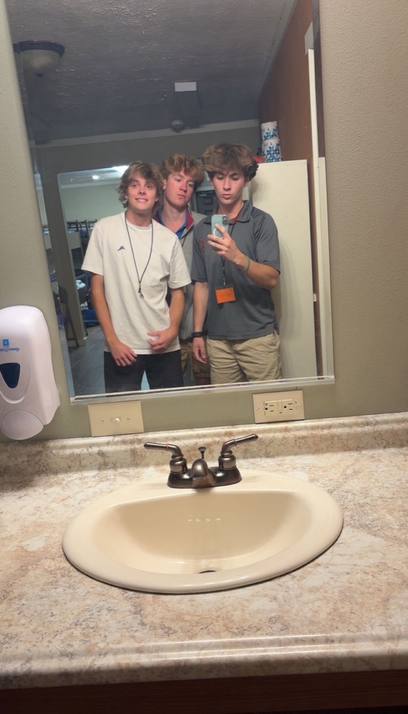 Mirror selfie of Colin with two friends